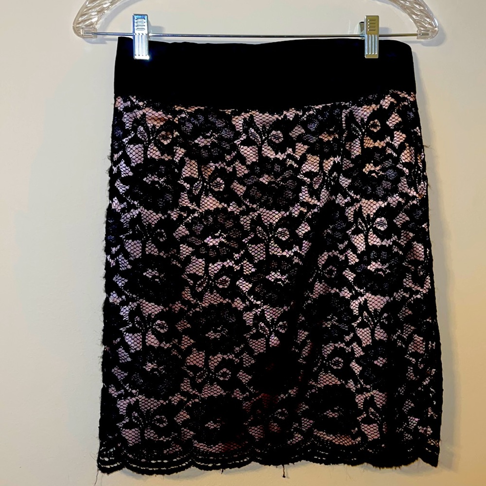 A black and cream colored skirt with a flower design